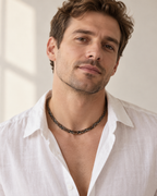 The brown flat python mesh necklace styled on a man in natural daylight.