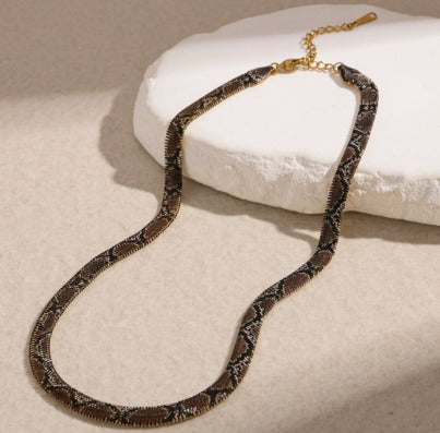 Supplier photograph of the brown flat python mesh necklace, showing the clasp and extender.