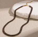 Supplier photograph of the brown flat python mesh necklace, showing the clasp and extender.