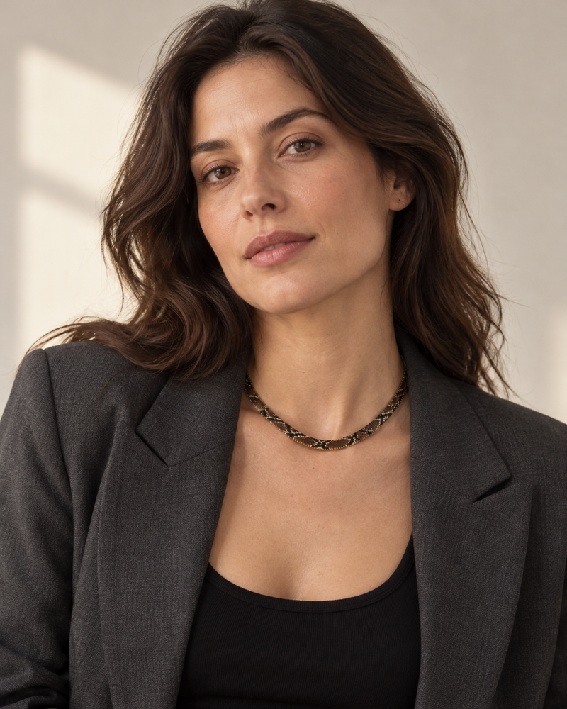 The brown flat python mesh necklace styled on a woman in natural daylight.