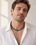 The green flat python mesh necklace styled on a man in natural daylight.