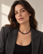 The purple flat python mesh necklace styled on a woman in natural daylight.