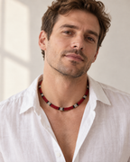 The red-ivory flat python mesh necklace styled on a man in natural daylight.