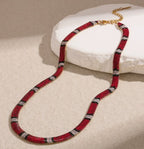 Supplier photograph of the red-ivory flat python mesh necklace, showing the clasp and extender.