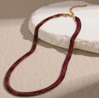 Supplier photograph of the red flat python mesh necklace, showing the clasp and extender.