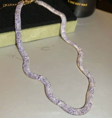 Supplier photograph of the silver flat python mesh necklace, showing the clasp and extender.