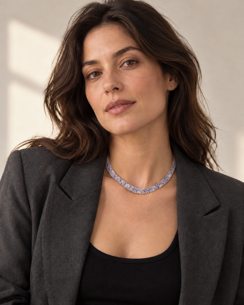 The silver flat python mesh necklace styled on a woman in natural daylight.